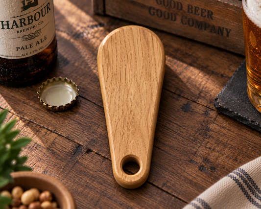 Solid oak bottle opener showing shaped handle and engraved detail